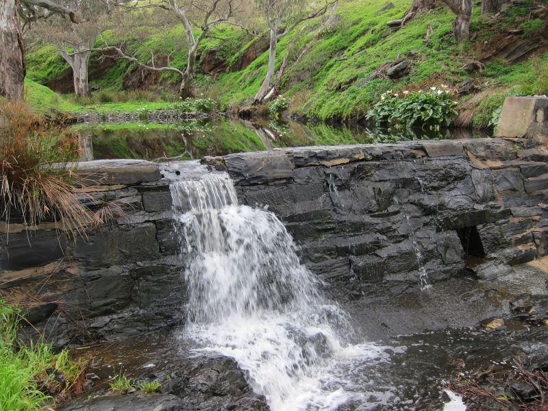 Water flowing over stone weir