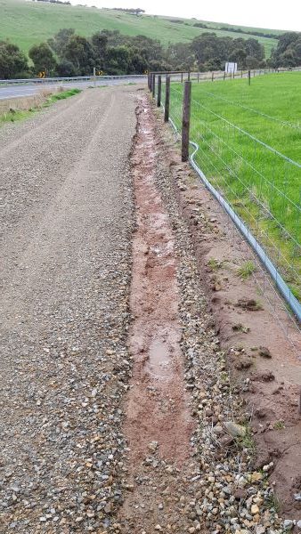Cutting into roadway by water