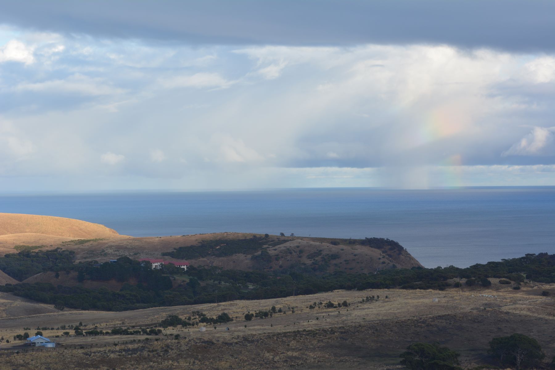 Rain and Rainbow over the sea